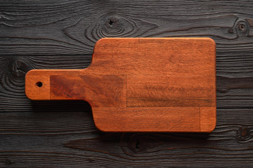 cutting board on wooden background top view