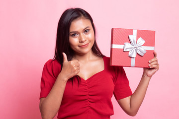 Young Asian woman thumbs up with a gift box.