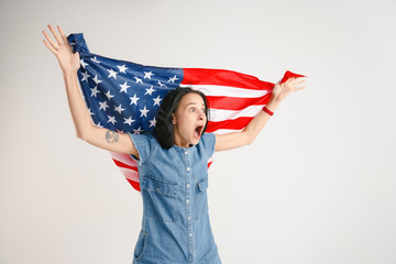 Celebrating an Independence day. Stars and Stripes. Young woman with the flag of the United States...