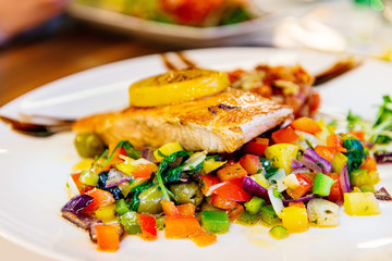 grilled salmon and lemon - french cuisine dish with tomato and salmon