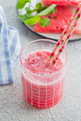 Healthy watermelon drink and fresh watermelon on light concrete background. Summer Drink Concept. Copy space