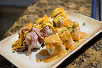 Closeup of delicious maki sushi on a white plate.