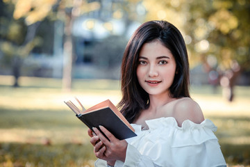 Fototapeta premium One women in Public park drink coffee and read a book