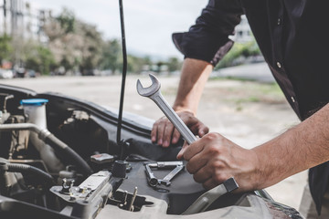 Services car engine machine concept, Automobile mechanic repairman hands repairing a car engine...