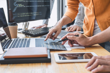 Writing codes and typing data code technology, Programmer cooperating working on web site project...