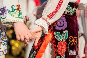 Foto op Canvas Close up of hands of young Romanian dancers perform a folk dance in traditional folkloric costume. Folklore of Romania © Zoran