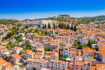 Fototapeta na wymiar Croatia, city of Sibenik, panoramic view of the old town center, houses on hills and old fortress of St Michael over the city