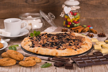 Sweet chocolate pizza with cookies.