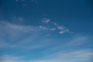 Naklejka na ściany i meble white cirrus clouds against a blue sky