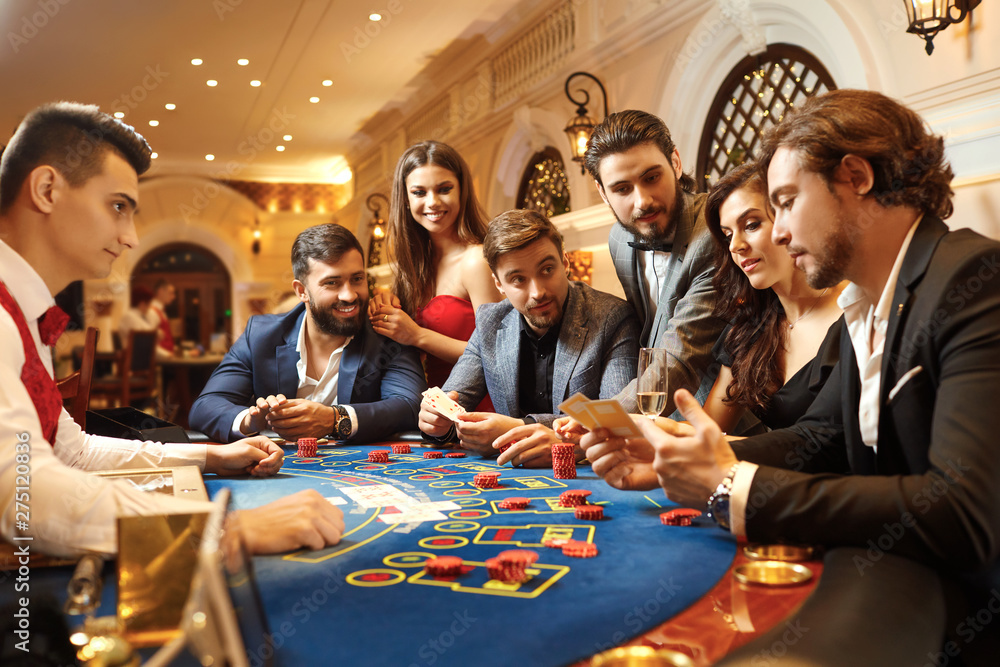 Wall mural a group of people playing gambling in a casino