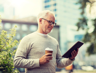 technology, people and lifestyle concept - senior man with tablet pc computer and coffee on city street