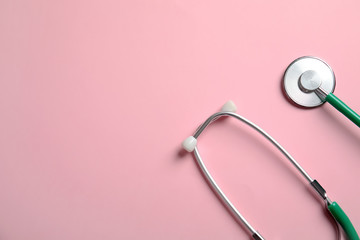 Stethoscope with space for text on color background, top view. Medical tool