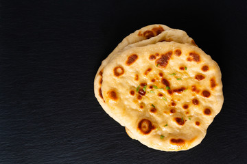 Food concept Homemade organic yogurt Naan on black slate board with copy space