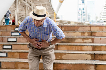 Asian old man, have an upset stomach, on the train station While he was traveling, to elder and...