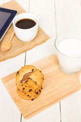 Soft batch chocolate chip cookies with milk and coffee with tablet; snack for two generations