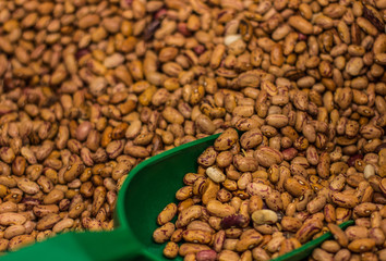 brown food beans background and weight spoon for selling in supermarket