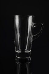 Clean empty latte glass on black background