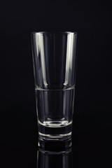 New empty tall glass on black background