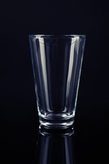 New empty tall glass on black background
