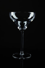 Clean empty cocktail glass on black background