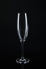 New empty champagne glass on black background