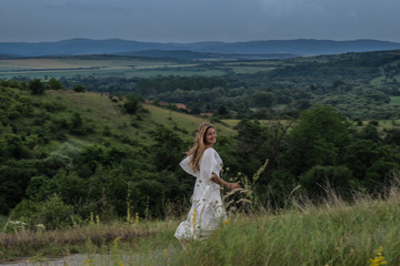 Fototapeta premium Girl in a field of flowers