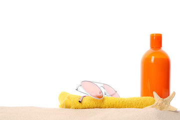 Different stylish beach accessories on sand against white background, space for text