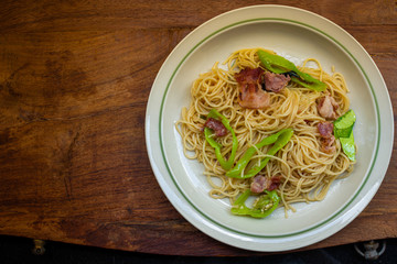 A dish of spaghetti on wooden table