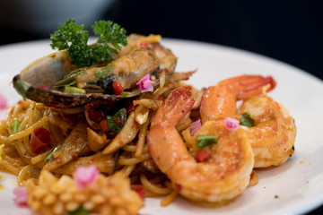 Seafood spaghetti in a white ceramic dish