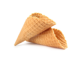 Empty crispy waffle cones for ice cream on white background