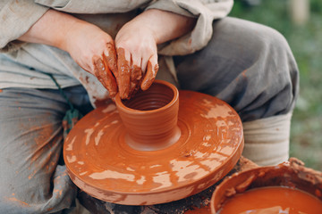 Fototapeta na wymiar Potter makes a pot of clay