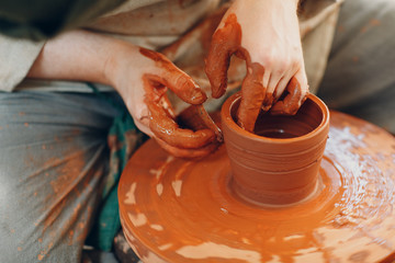 Potter makes a pot of clay