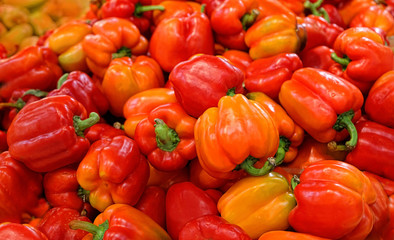 Bulgarian sweet red pepper background close up. pile of red bell peppers as background, texture. Bulgarian pepper on counter in market. soft focus