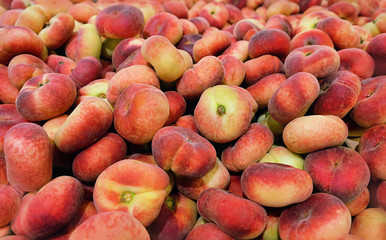 fig peach, flat peaches. delicious juicy ripe fig peaches background. fresh tasty peaches fruit at...