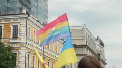 Close-up view of rainbow color flag at the annual Pride Parade LGBT. Gay Pride Parade with rainbow colors and flags in city center