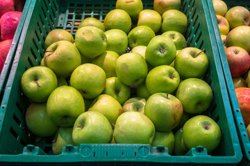 delicious juicy apples on the supermarket counter
