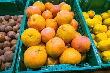 fresh juicy grapefruit on the counter of the supermarket