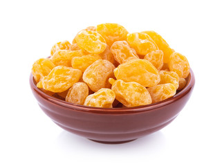 Dry yellow plums in bowl on white background. top view