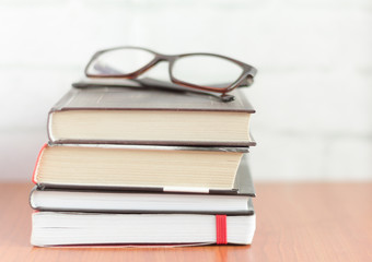 stack of books and glasses on the table,fiction for reading