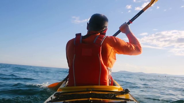 Man paddling sea kayak
