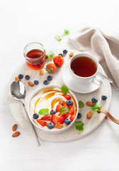 yogurt with strawberry blueberry honey almond for breakfast