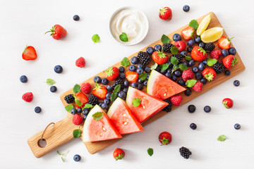 fruit and berry platter over white. blueberry, strawberry, raspberry, blackberry, watermelon