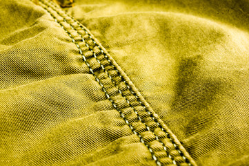 clothing items stonewashed cotton fabric texture with seams, clasps, buttons and rivets, macro