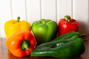 Yellow, green, red, and orange bell peppers with a pair of poblano peppers