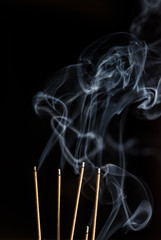 Incense sticks burning with smoke