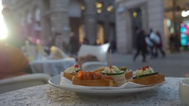 Close-up video with brusquest. Restaurant. Out of focus people on the street in background.