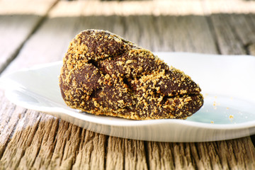 Chocolate potato cake on white plate. Sweet Russian dessert, photo for the restaurant menu