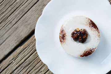 Coffee tiramisu cake on a white plate. Delicious beautiful festive dessert top view