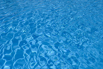 Rippled surface of blue water in swimming pool