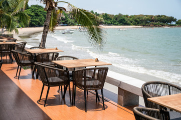 Wooden dining table on restaurant patio at seaside